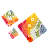 The Crowd Pleaser candy board by Candy Goddess — assorted rainbow gummies arranged on a reusable acrylic board