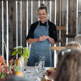 Chef presenting at an In Autumn cooking demonstration in a rustic barn