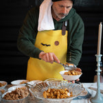 Chef serving baked dishes at an In Autumn tasting table
