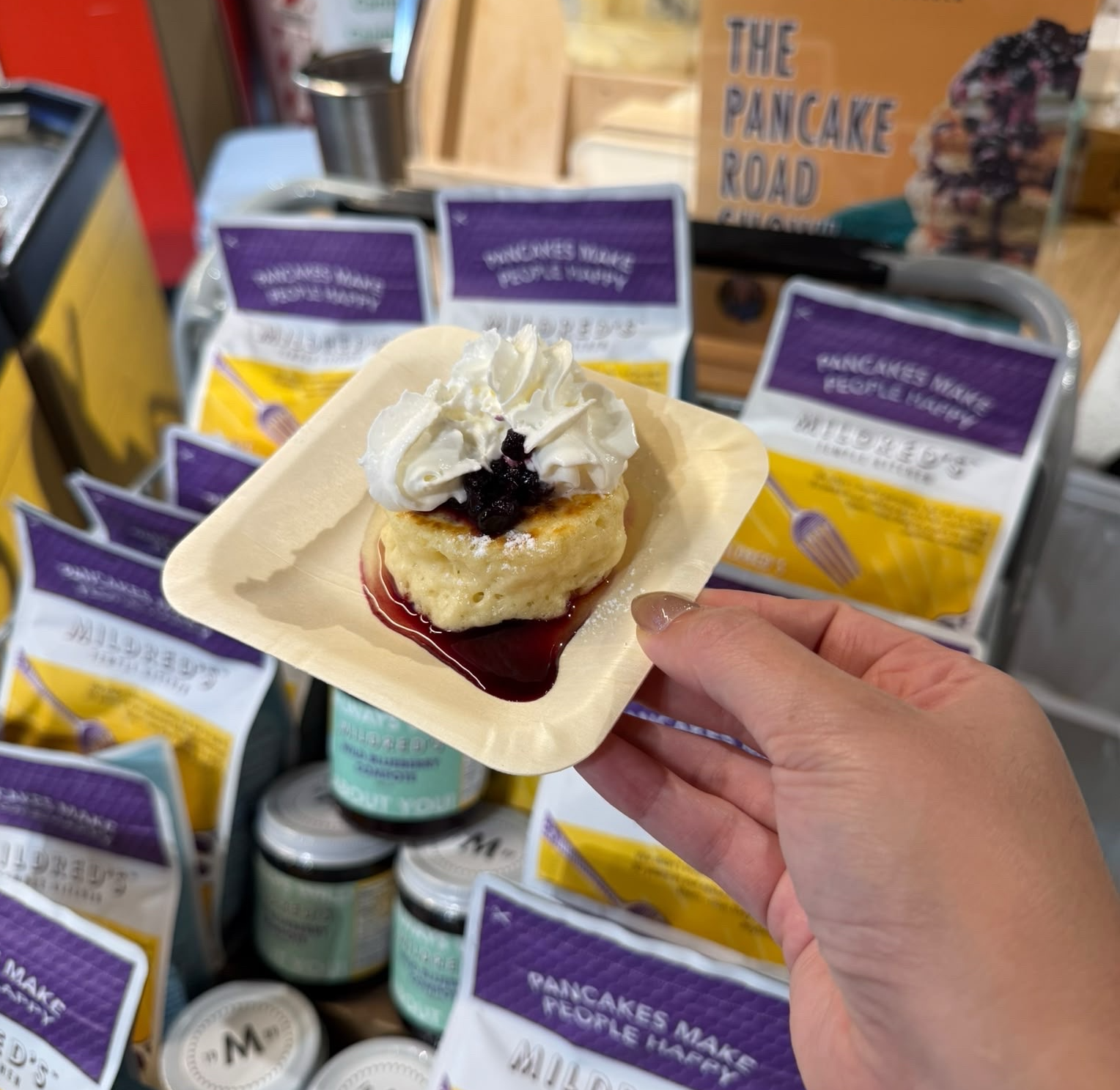 Pancake dessert sample held up at an In Autumn vendor stall