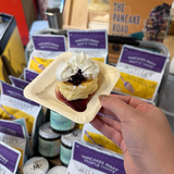 Pancake dessert sample held up at an In Autumn vendor stall