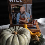 Cookbook displayed beside heirloom squash at In Autumn