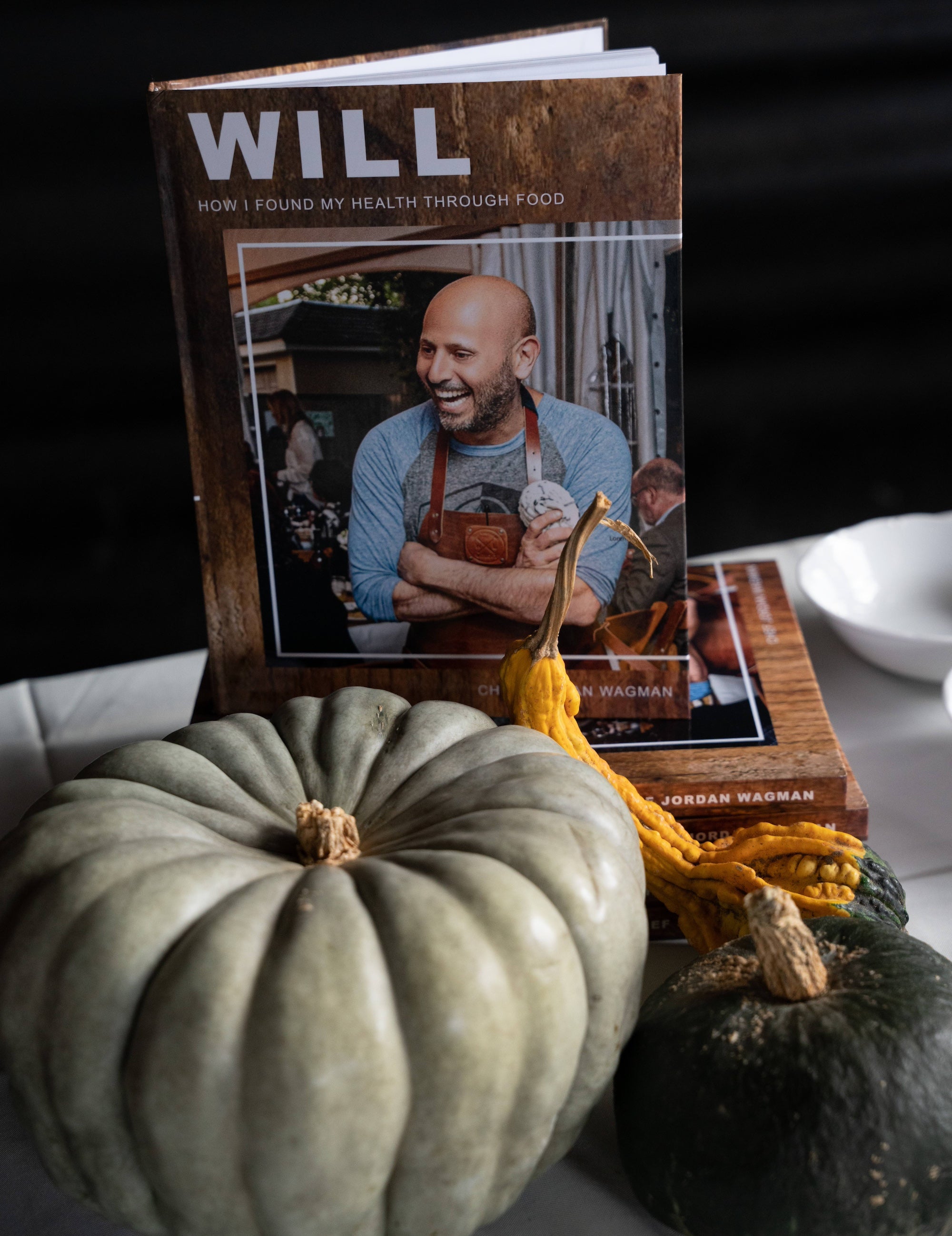 Cookbook displayed beside heirloom squash at In Autumn