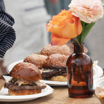 Gourmet smash burger with flowers at a Hale Muskoka event