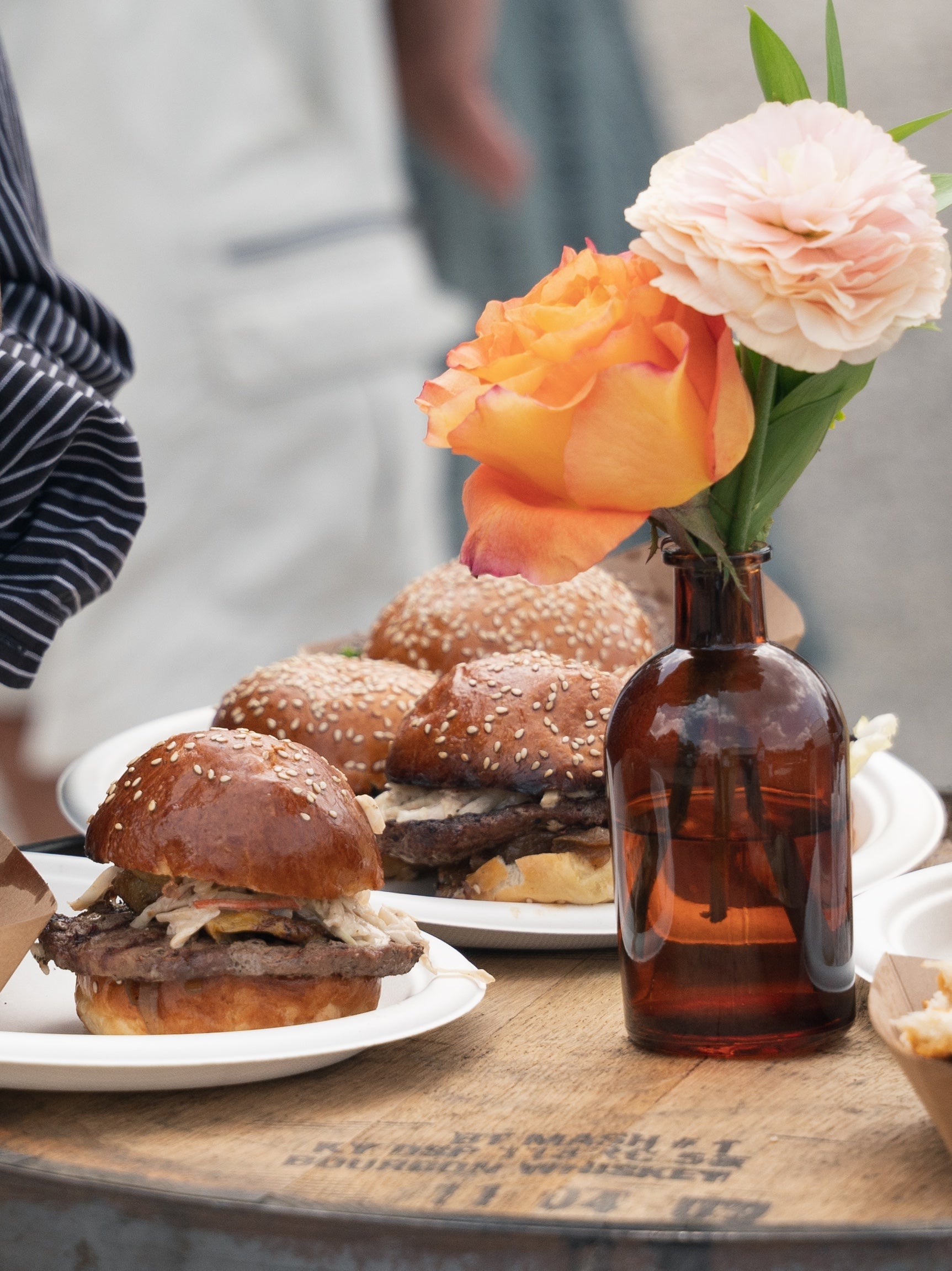 Gourmet smash burger with flowers at a Hale Muskoka event
